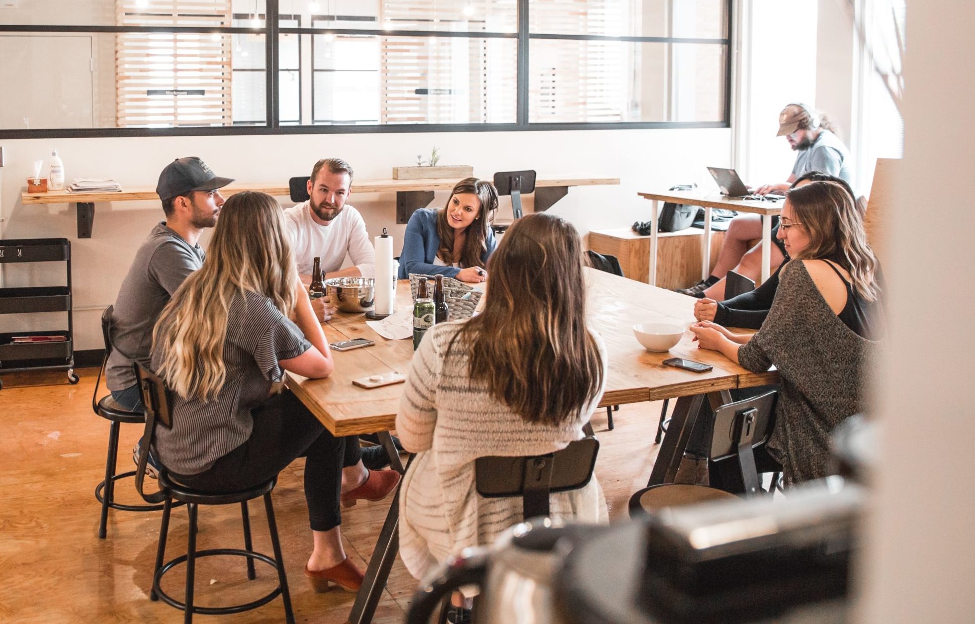 talking people sitting beside table